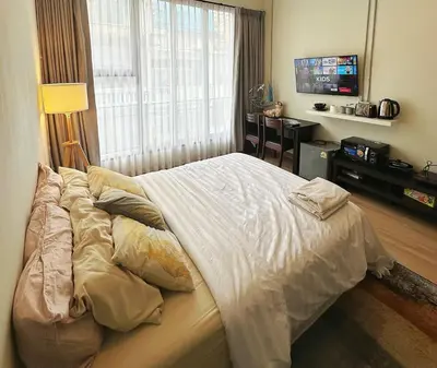 a large bed in a bedroom with a window at 260m walk to BTS Prakanong in Bangkok