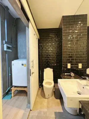a bathroom with a white toilet and a sink at 260m walk to BTS Prakanong in Bangkok