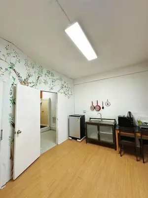 an empty room with a kitchen and a desk and a door at Top Location! 800m MRT Rama9 in Bangkok