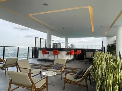 a balcony with chairs and a bar on a building at Rama9 Loft Life in Bangkok