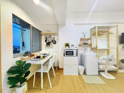 a small kitchen with a table and a microwave at Secret Muji Vintage Building ห้องลับมูจิในตึกวินเทจ in Ban Song Hong