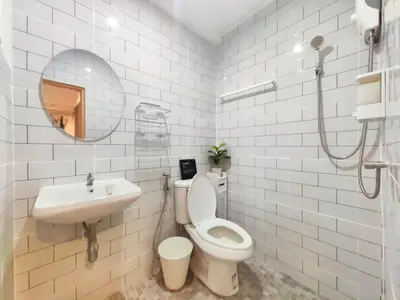 a bathroom with a toilet and a sink and a mirror at Secret Muji Vintage Building ห้องลับมูจิในตึกวินเทจ in Ban Song Hong