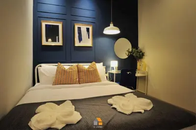 a bedroom with a large bed with two towels on it at Baan Sri-kram 550m from MRT Taopoon in Bang Su