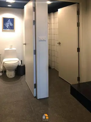 a bathroom with a toilet and a stall with a door at Baan Sri-kram 550m from MRT Taopoon in Bang Su