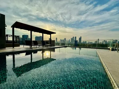 a swimming pool on the roof of a building at Bright & Spacious Apartment in Bangkok
