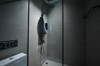 a shower in a bathroom with a glass shower backdoor at baansaensaep in Pratunam