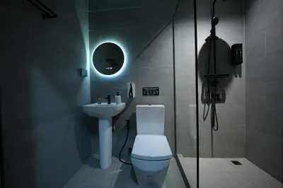 a bathroom with a toilet and a sink at baansaensaep in Pratunam