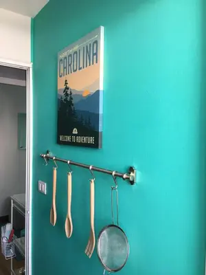 a blue wall with utensils hanging on a rack at White Turquoise -1 Bedroom Apartment- in Bangkok