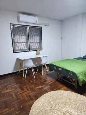 a bedroom with a bed and a table and chairs at Creative Bangkok twin bed in Sathani Bang Khen