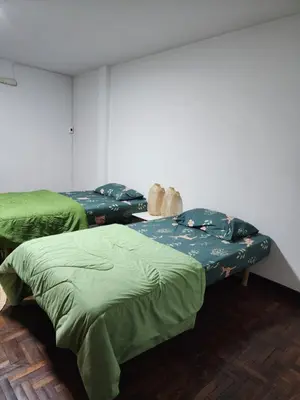 two beds in a room with green sheets at Creative Bangkok twin bed in Sathani Bang Khen