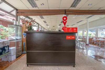 a counter in a restaurant with a red sign above it at OYO 1089 Baan Boran in Bangkok