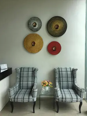 two chairs in a room with a wall with somewheels at Pannapat Place in Bangkok