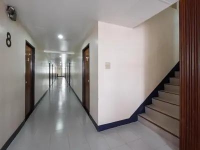 a hallway with a staircase in a building at Muangphol Mansion in Bangkok