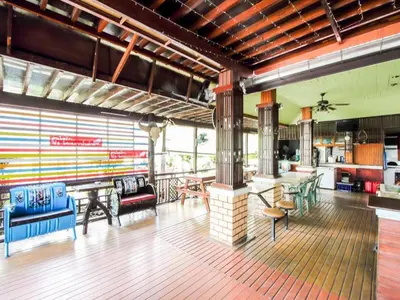 a large room with tables and chairs in it at Thai Garden Resort in Bangkok