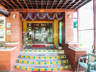 a front door of a building with stairs leading to it at Thai Garden Resort in Bangkok