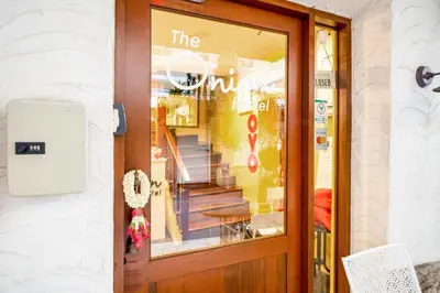 a door to a store with a sign on it at OYO 895 The Onion Hostel in Bangkok