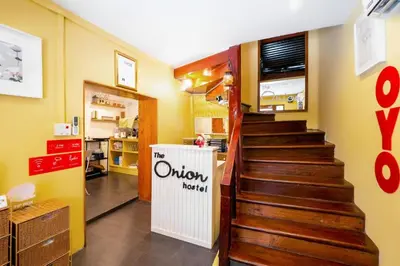a stairway in a kitchen with a staircase in a room at OYO 895 The Onion Hostel in Bangkok
