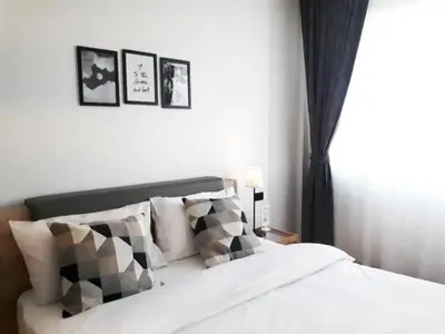 a bedroom with a bed with black and white pillows at Oh Boutique Guesthouse. in Bangkok