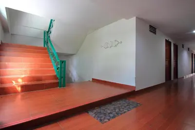 a room with a staircase and a wooden floor at OYO 410 Diamond Boutique Hostel in Bangkok