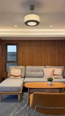 a room with two couches and a table and a table at Hyde Residence Ladprao48 in Bangkok