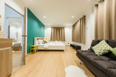 a living room with a bed and a couch at Coco59- Private 3BR Pool Villa in Bangkok