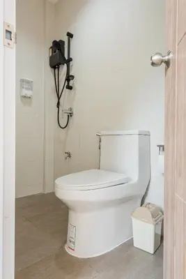 a bathroom with a toilet with a camera on the wall at Coco59- Private 3BR Pool Villa in Bangkok