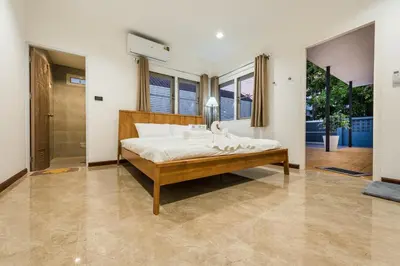 a bedroom with a large bed in a room at Coco59- Private 3BR Pool Villa in Bangkok