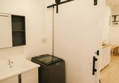 a bathroom with a trash can next to a sink at City Silom I King Bed I Sleep 3 I 2 Bedroom in Bangkok