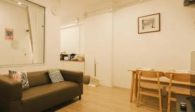 a living room with a couch and a table at City Silom I King Bed I Sleep 3 I 2 Bedroom in Bangkok