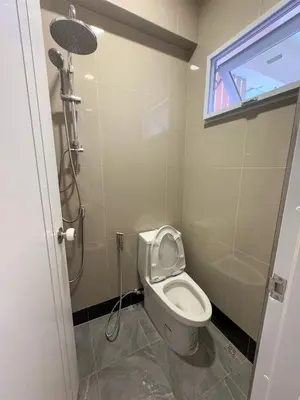 a small bathroom with a toilet and a shower at Apartment Near Big Buddha in Bangkok Yai