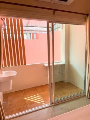 a bathroom with a sliding glass door with a toilet at Apartment Near Big Buddha in Bangkok Yai