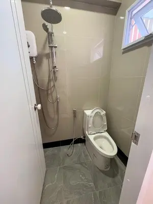 a small bathroom with a toilet and a shower at Apartment Near Big Buddha in Bangkok Yai