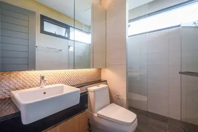 a bathroom with a sink and a toilet at MonochromeDesignerPool Villa in Bangkok