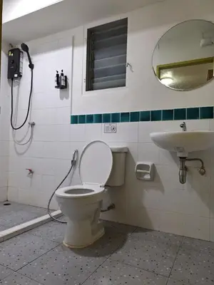 a bathroom with a toilet and a sink at Happy 2 Hotel Patunam in Bangkok