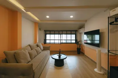 a living room with a couch and a tv at HAUS 924 l 5-Level Sanctuary in Ekkamai in Bangkok