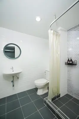 a bathroom with a toilet and a sink and a shower at XX Mitr Inn The Grand Palace Bangkok - Samyot in Bangkok