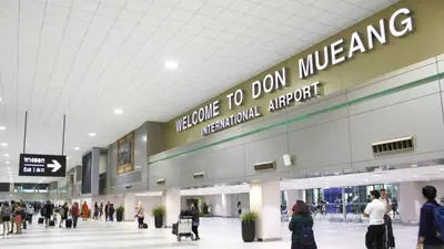 a group of people walking around an airport at The Riche Boutique Hotel Don Mueang Airport in Bangkok