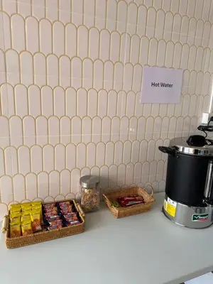 a counter with two baskets of food and a coffee pot at Au samlor guesthouse in Chinatown