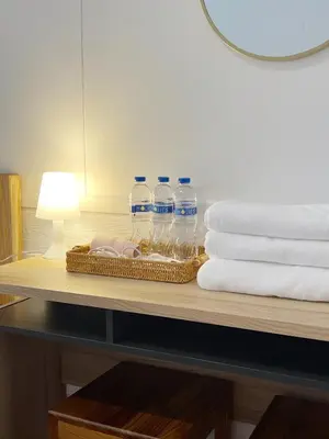 a tray of water bottles on a table with towels at Au samlor guesthouse in Chinatown