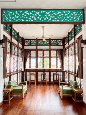a room with a table and chairs and windows at Au samlor guesthouse in Chinatown