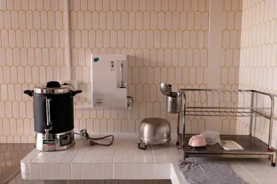 a kitchen with a coffee maker on a counter at Au samlor guesthouse in Chinatown