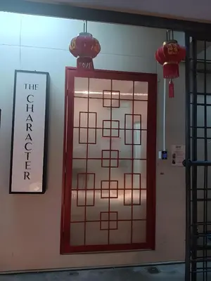 a door in a room with a sign on the wall at XX The Character China Town - เดอะ คาแรคเตอร์ เยาวราช in Samphanthawong