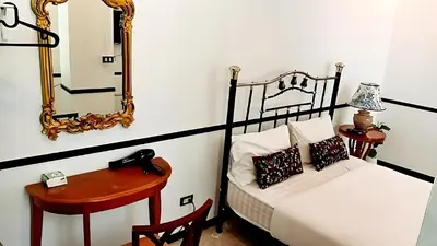 a bedroom with a bed and a mirror and a table at XX The Character China Town - เดอะ คาแรคเตอร์ เยาวราช in Samphanthawong