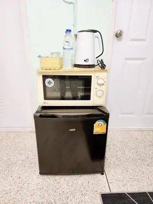 a microwave sitting on top of a refrigerator at 804-STP Homely room Free Wi-Fi and Near BTS line in Bangkok