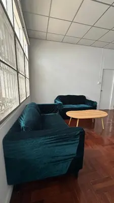 a living room with two couches and a table at ESSENCE Home in Bangkok