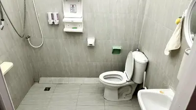 a small bathroom with a toilet and a sink at ESSENCE Home in Bangkok