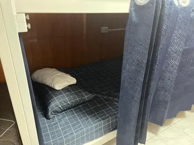 a small room with a bed with a pillow in it at ESSENCE Home in Bangkok