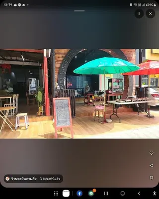 two umbrellas on display in front of a restaurant at Tawan Room#6 in Bangna