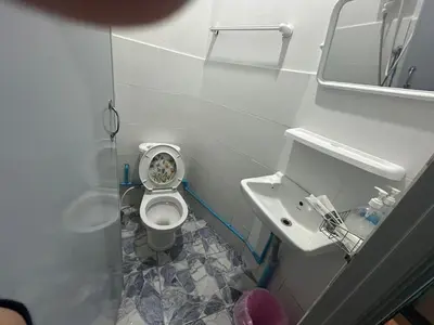 a small bathroom with a toilet and a sink at Asia Mahanakhorn Travel in Bangkok