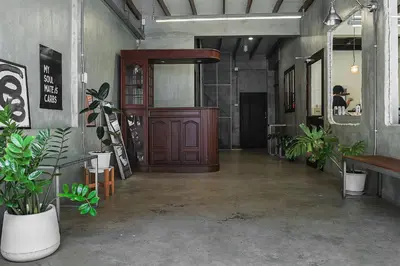 a lobby with a wooden door and some plants at Siam Breeze Inn - Self Check-in in Bangkok